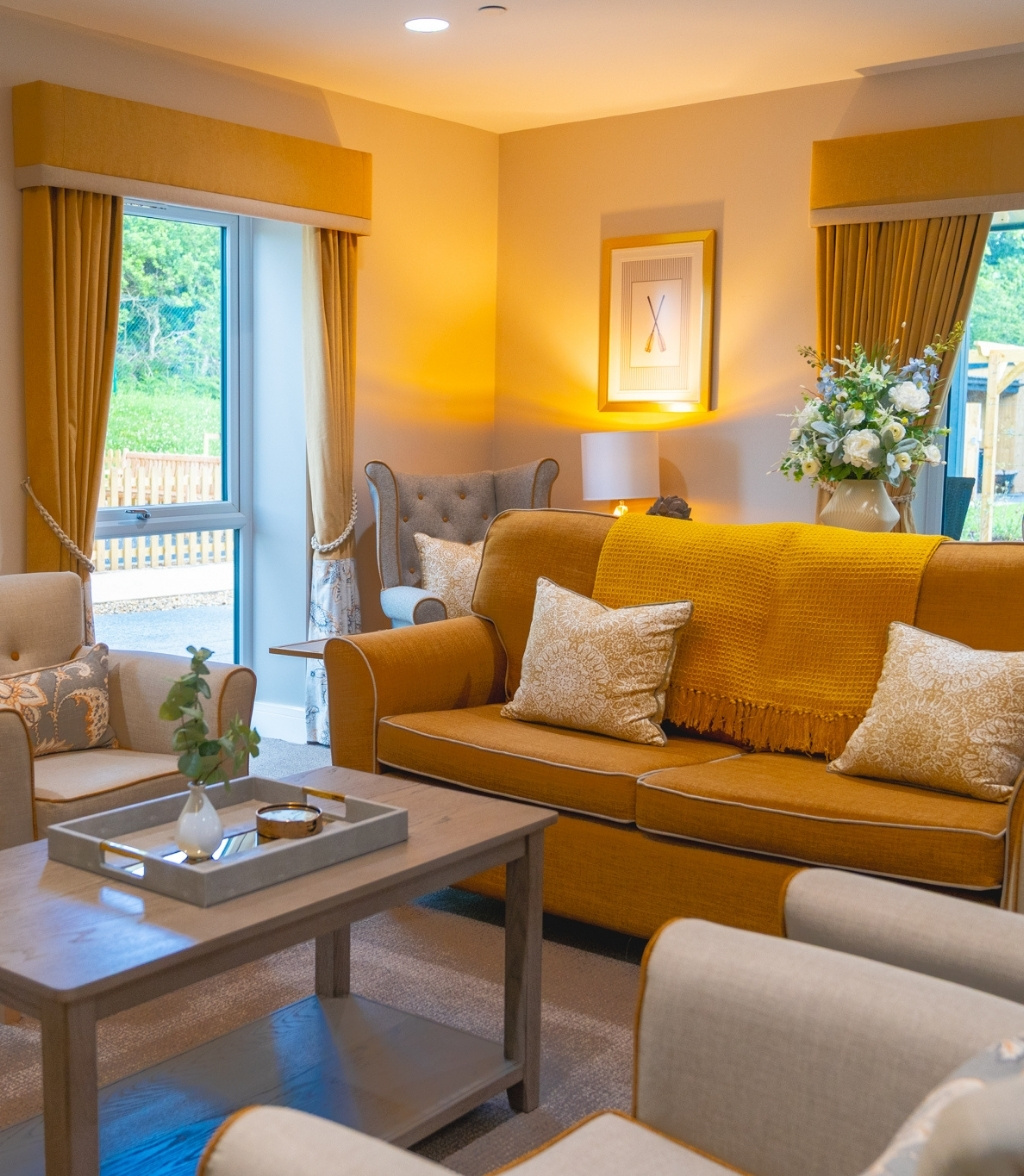 A cozy living room featuring a sofa, a coffee table, and a side table, creating a welcoming atmosphere.