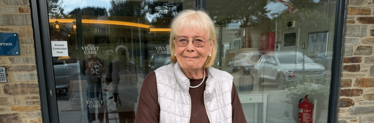 A female resident stood outside the front of Bayards Court smiling