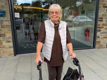 A female resident stood outside the front of Bayards Court smiling